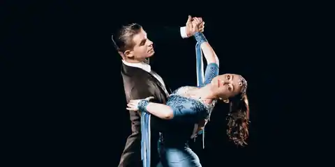 Ballroom dancers mid-performance at a competition