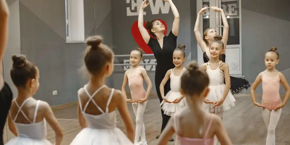 Ballet teacher guiding young students in a studio