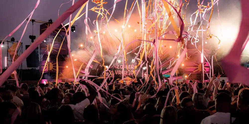 Festival crowd with colorful ribbons at twilight